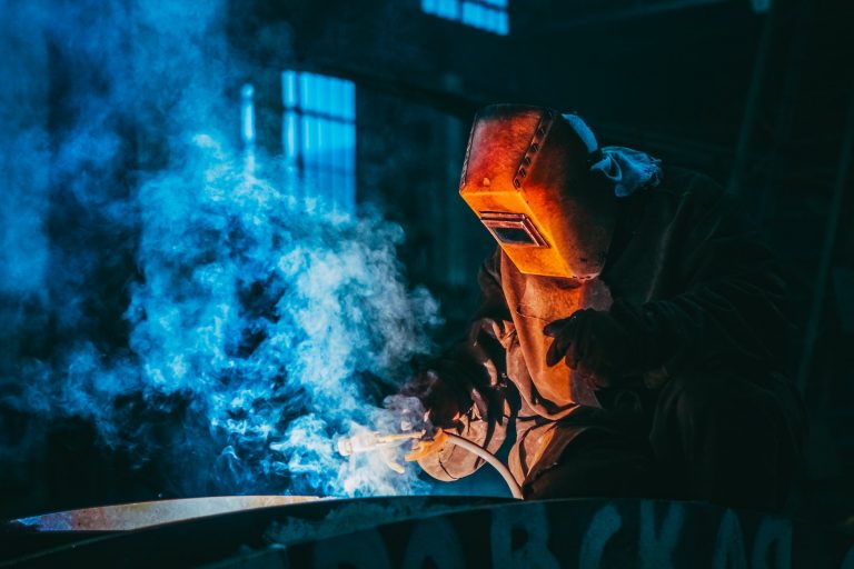 Person Welding Wearing a Prootective Metal Mask